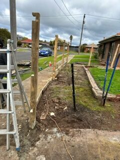 timber front fence project posts being concreted into ground